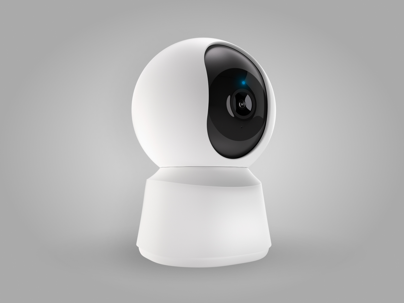 Caméra de surveillance blanche en forme de sphère, posée sur une base ronde, sur fond gris.