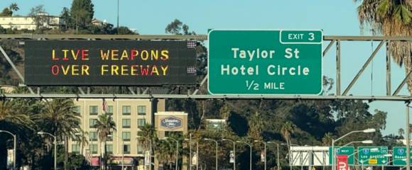 Un panneau (g) d'autoroute informe les automobilistes de la présence d'armes réelles le 18 octobre 2025 à San Diego, en Californie Un panneau (g) d'autoroute informe les automobilistes de la présence d'armes réelles le 18 octobre 2025 à San Diego, en Californie
